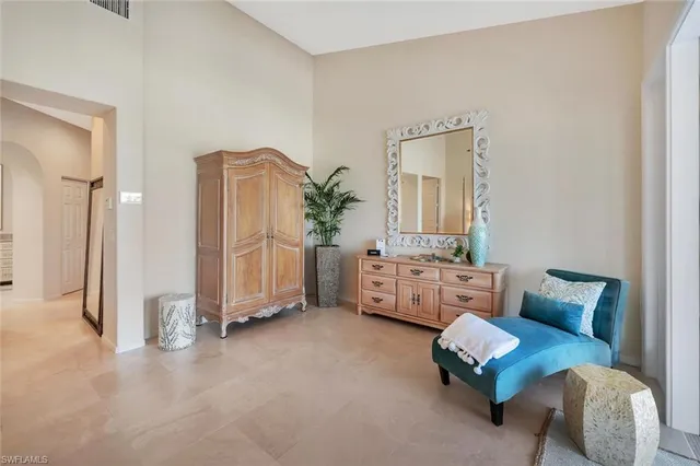 a living room with furniture and a large mirror