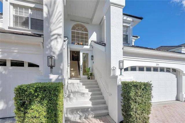 a front view of a building with a garden