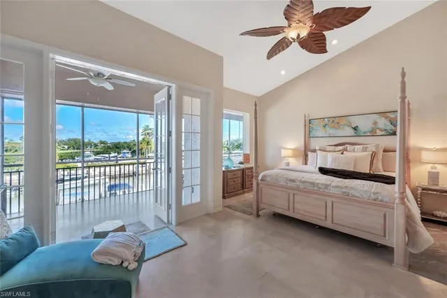 a bedroom with a bed and large window