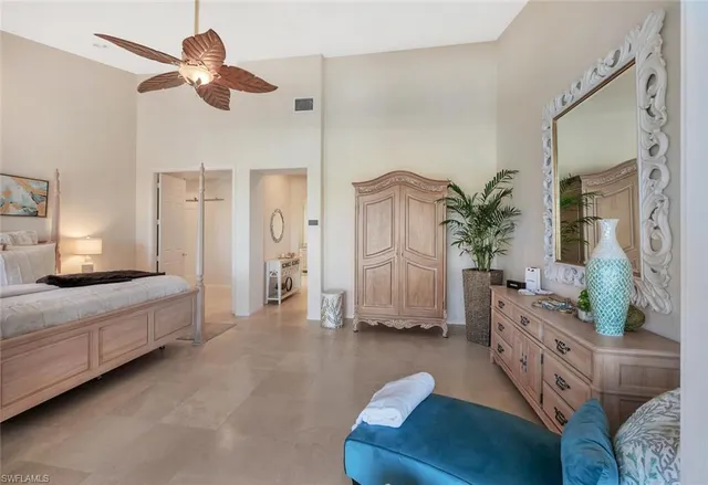 a spacious bedroom with a bed and a couch