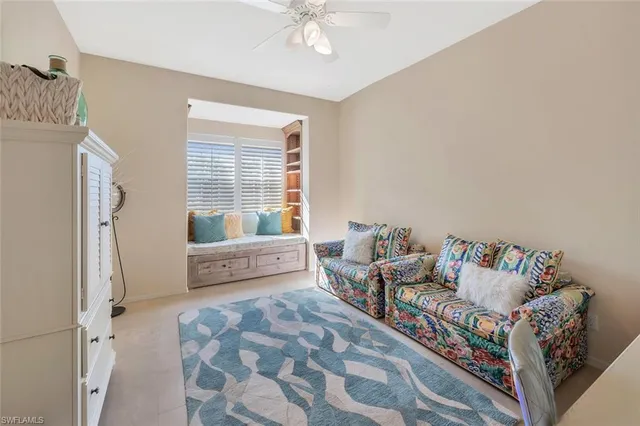 a spacious bedroom with a bed and a chandelier