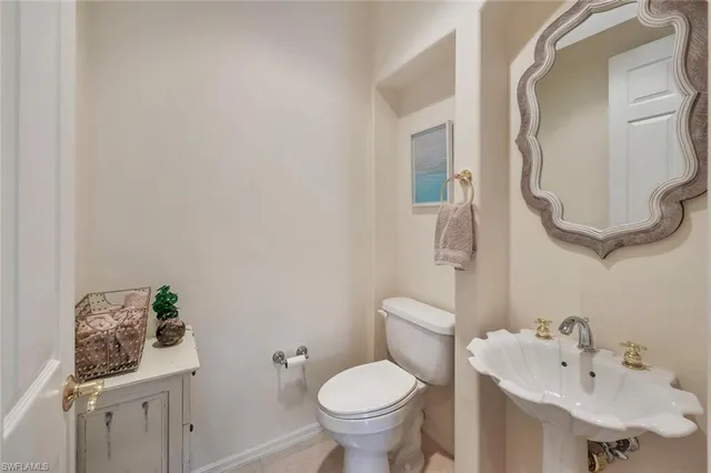 a bathroom with a sink mirror and toilet