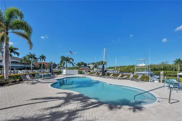 a view of a swimming pool and lounge chairs