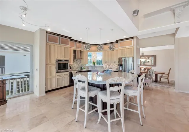a large kitchen with a table and chairs