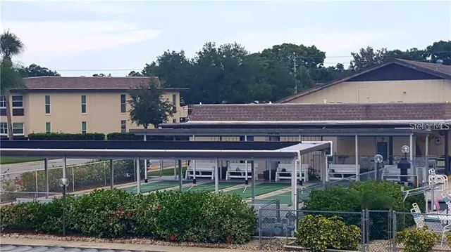 a view of a house with swimming pool and sitting area