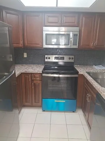 a stove top oven sitting inside of a kitchen