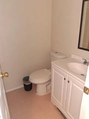 a white toilet sitting next to a bathroom sink
