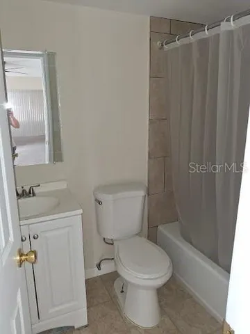 a bathroom with a toilet and shower