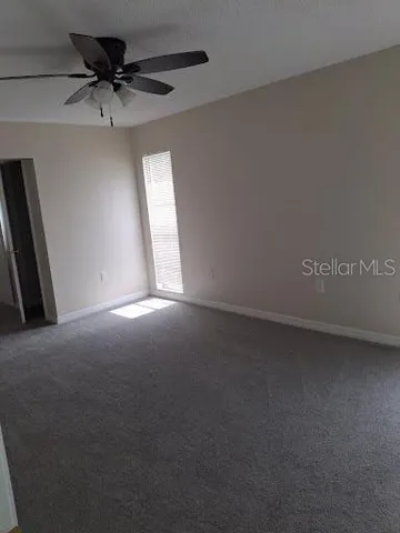 a view of an empty room with a closet