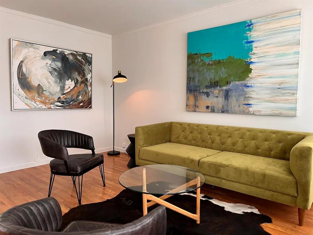a living room with furniture and a painting