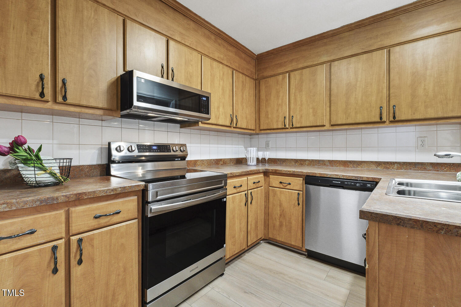120 Joanne Circle Cary, NC 27513 - Photo 15 of 34 a kitchen with stainless steel appliances granite countertop a sink stove and microwave