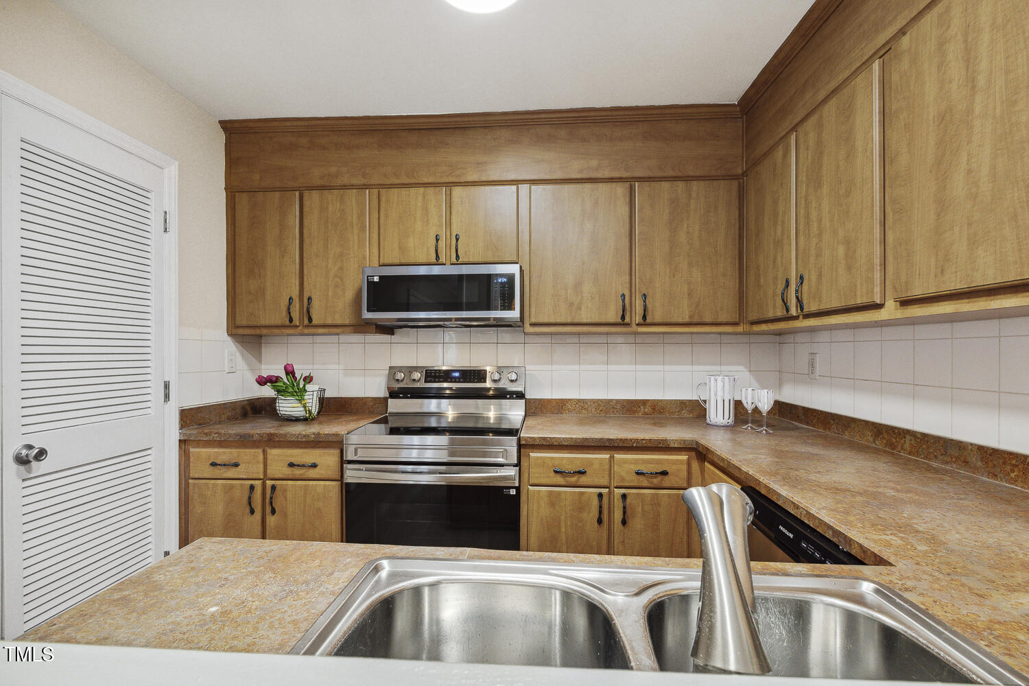 120 Joanne Circle Cary, NC 27513 - Photo 18 of 34 a kitchen with a sink a stove and cabinets