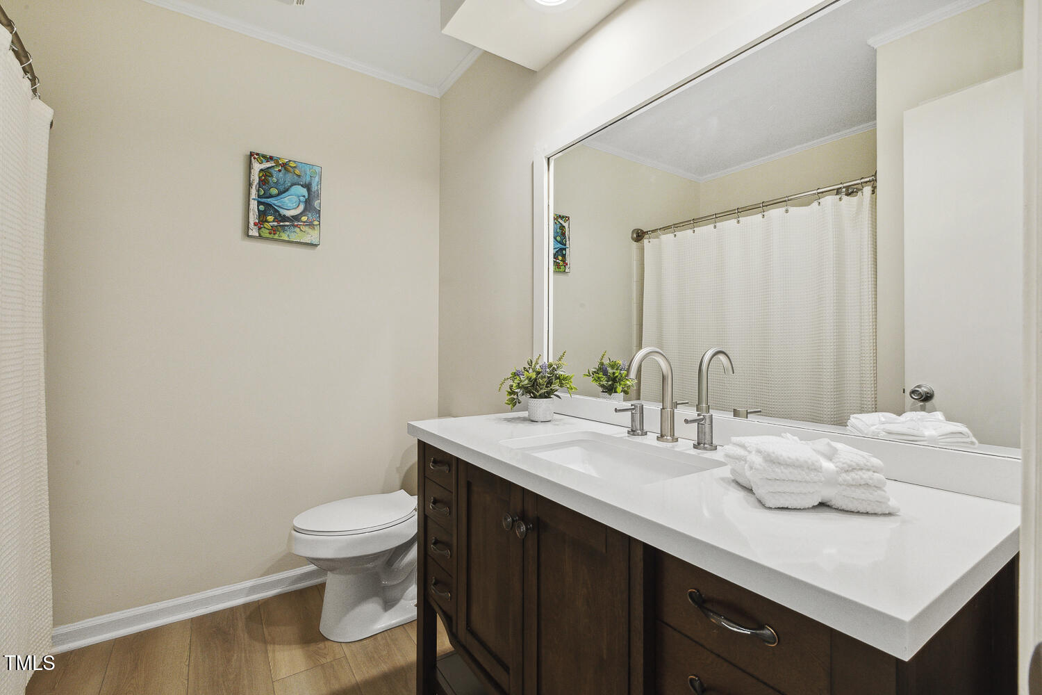 120 Joanne Circle Cary, NC 27513 - Photo 28 of 34 a bathroom with a granite countertop sink a toilet and a mirror