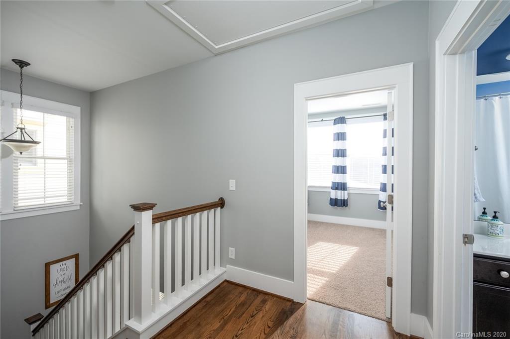 413 Hollyhock Lane Fort Mill, SC 29708 - Photo 11 of 29 a view of a hallway with wooden floor and a dining room
