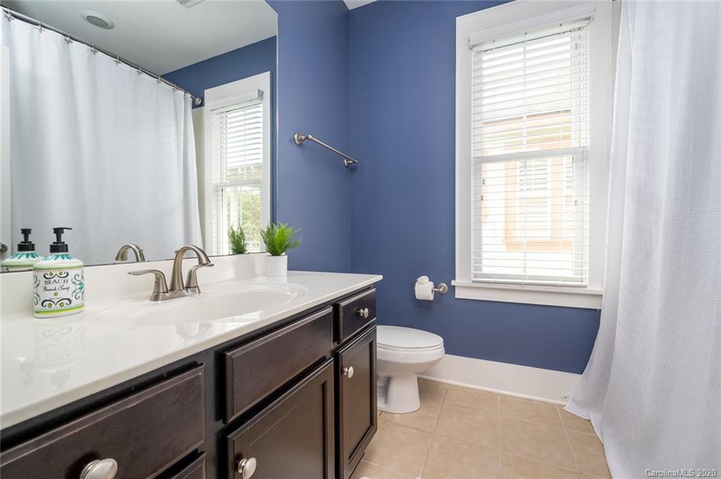 413 Hollyhock Lane Fort Mill, SC 29708 - Photo 13 of 29 a bathroom with a granite countertop sink a toilet a mirror and window