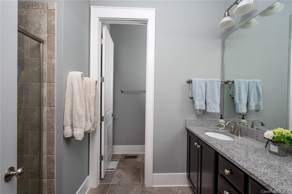 413 Hollyhock Lane Fort Mill, SC 29708 - Photo 18 of 29 a bathroom with a granite countertop shower sink and toilet