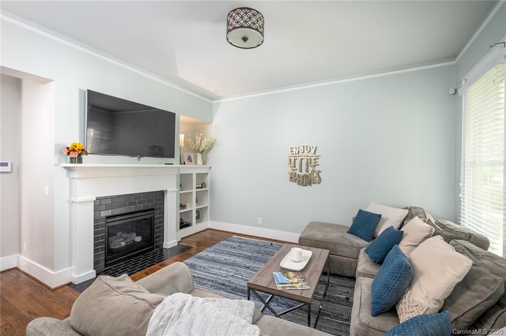 413 Hollyhock Lane Fort Mill, SC 29708 - Photo 5 of 29 a living room with furniture a fireplace and a flat screen tv