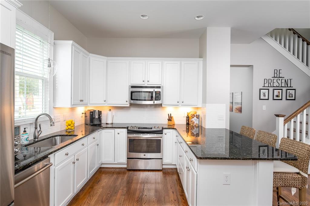 413 Hollyhock Lane Fort Mill, SC 29708 - Photo 7 of 29 a kitchen with stainless steel appliances granite countertop a stove a sink dishwasher and a refrigerator