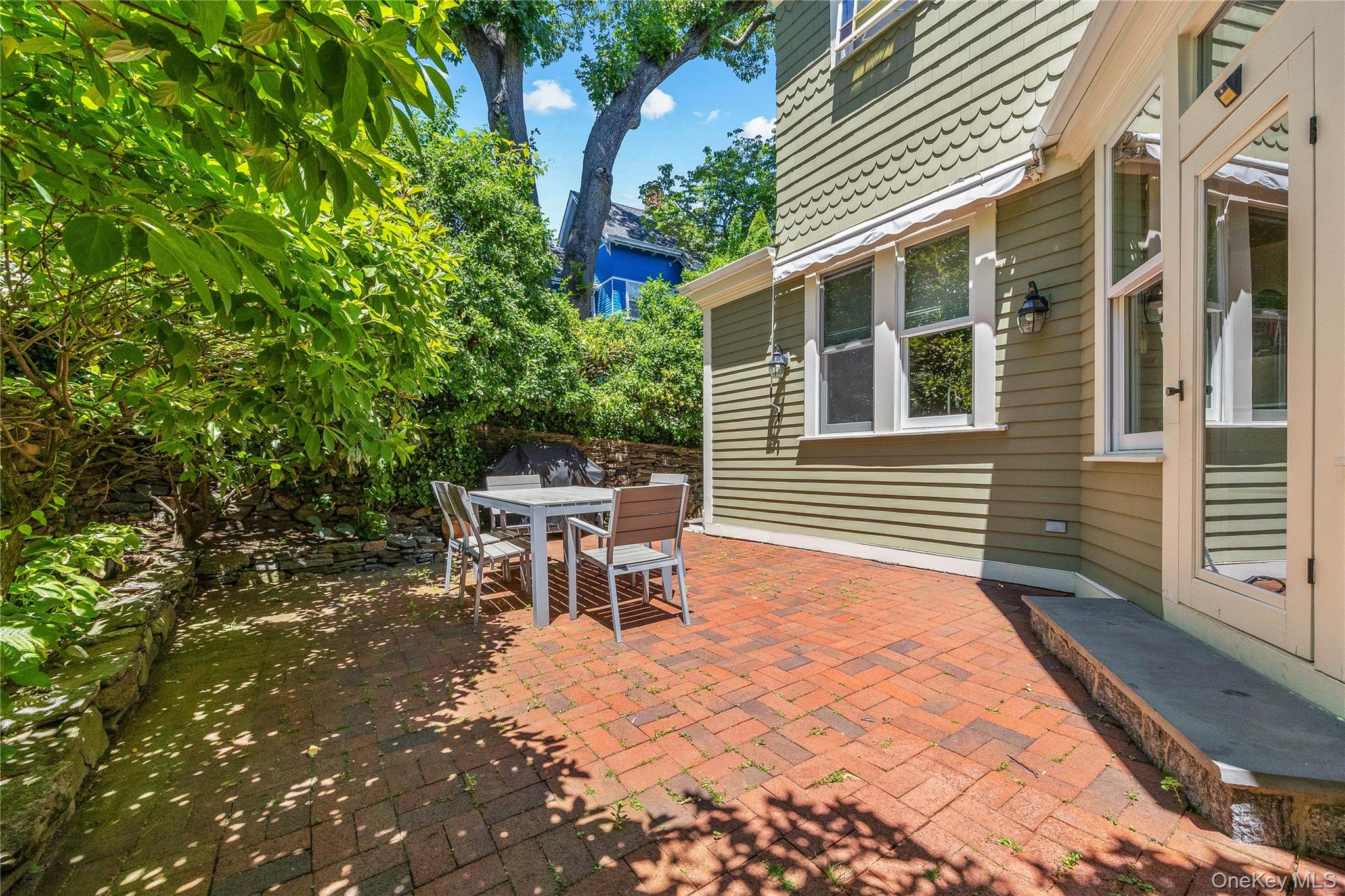 19 Howe Place Bronxville, NY 10708 - Photo 28 of 37 Expansive brick patio bordered by stone retaining walls