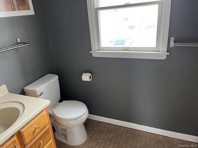 38 Hallock Avenue Smithtown, NY 11787 - Photo 14 of 16 a white toilet sitting next to a window