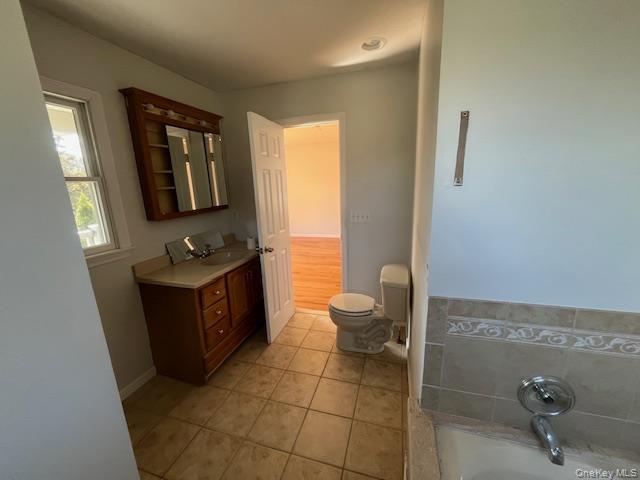 38 Hallock Avenue Smithtown, NY 11787 - Photo 15 of 16 a bathroom with a toilet mirror vanity and tub