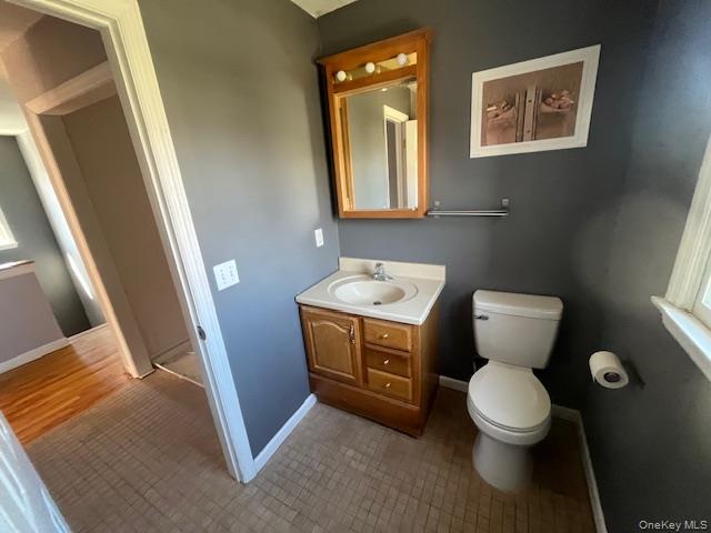 38 Hallock Avenue Smithtown, NY 11787 - Photo 16 of 16 a bathroom with a toilet sink and mirror