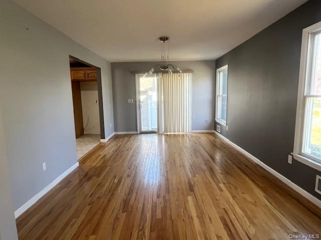 38 Hallock Avenue Smithtown, NY 11787 - Photo 6 of 16 a view of wooden floor and windows in a room