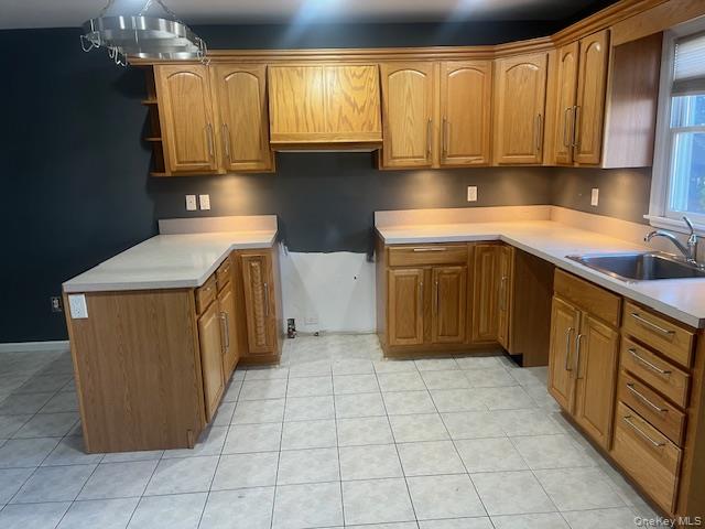 38 Hallock Avenue Smithtown, NY 11787 - Photo 7 of 16 a kitchen with a sink a stove top oven cabinets and a window