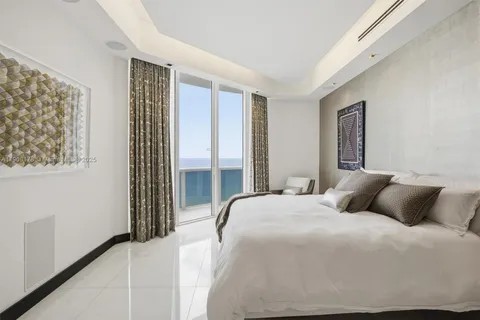 a bedroom with a bed and a mirror