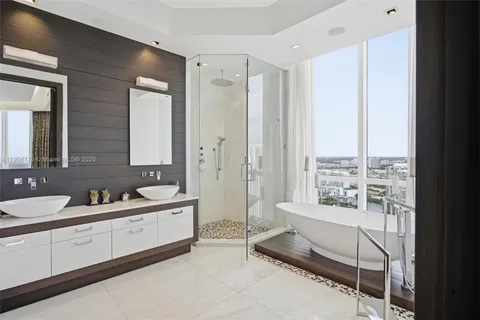 a bathroom with a granite countertop sink a toilet and shower