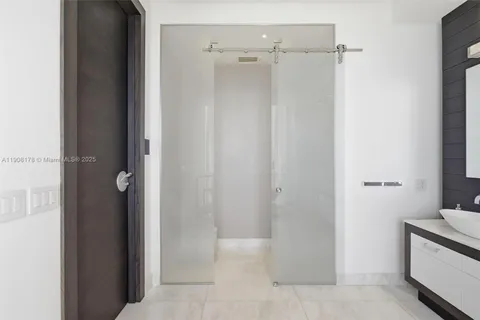 a large bed sitting in a bedroom next to a window