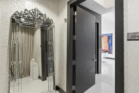 a living room with furniture floor to ceiling window and wooden floor