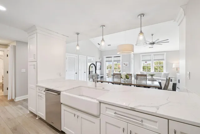 a view of a kitchen with kitchen island a sink stainless steel appliances and a window