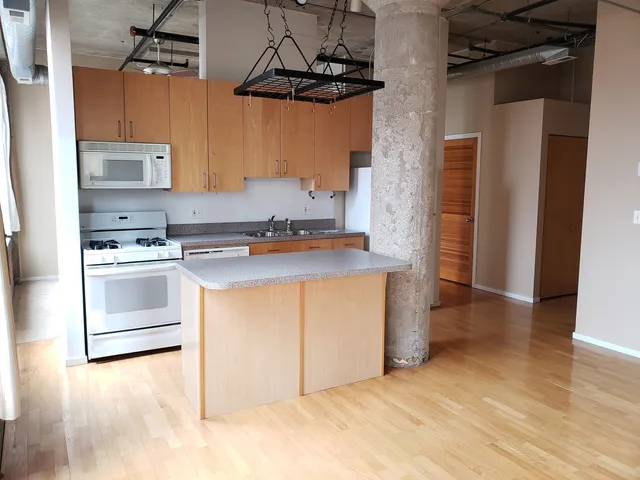 a kitchen with stainless steel appliances a stove a sink and a refrigerator