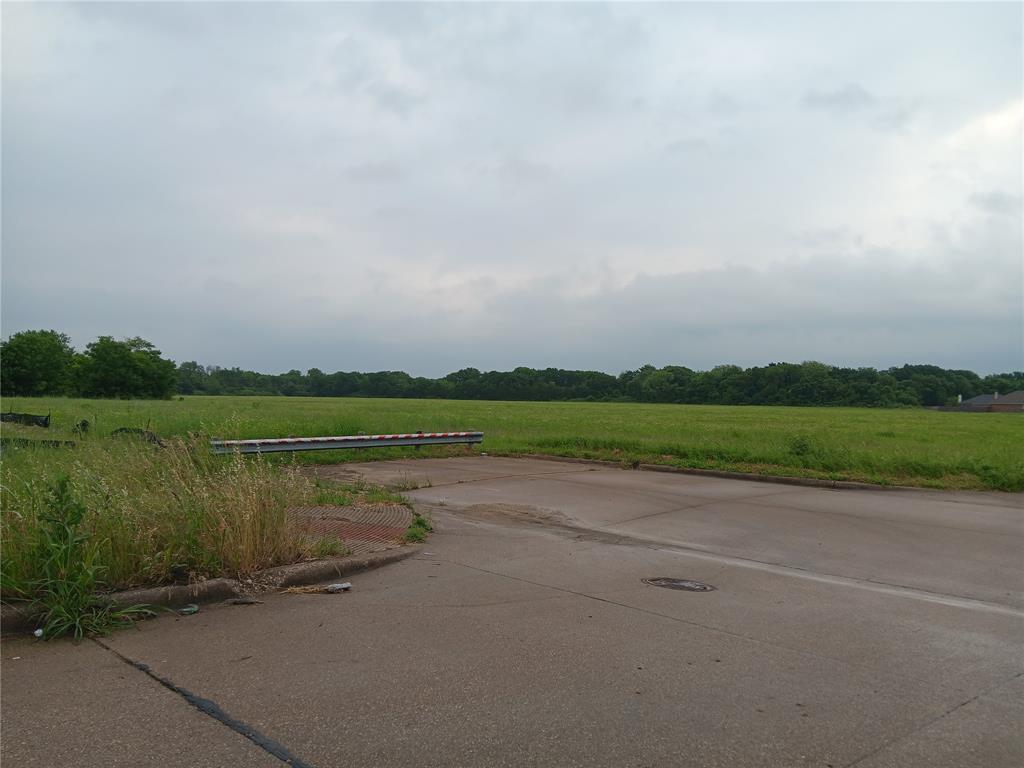 1400 West Wintergreen Road Lancaster, TX 75134 - Photo 2 of 4 View of concrete street featuring a boat ramp, curbs, and a rural view
