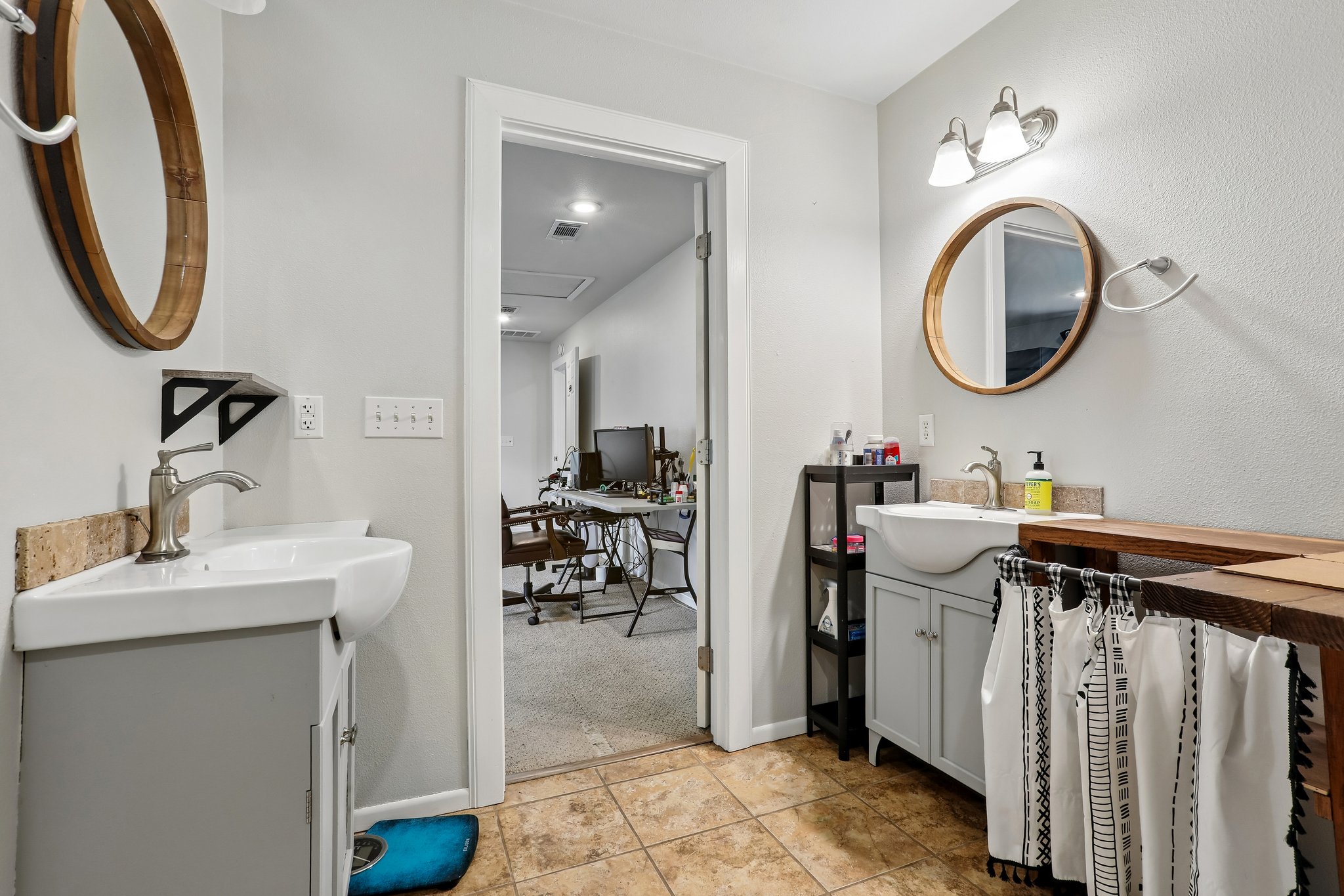1114 West 2nd Street Elgin, TX 78621 - Photo 18 of 31 Dual vanity sinks provide ample space for morning routines, connecting to a versatile adjacent office area.