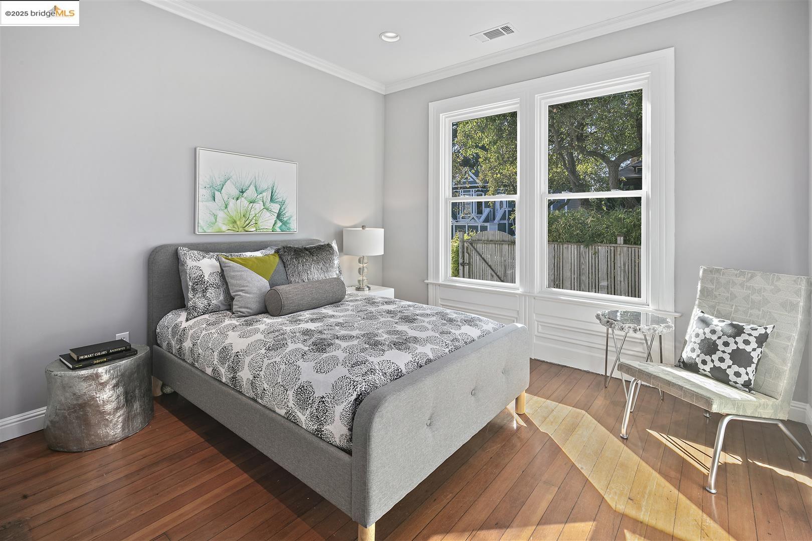 2439 Tenth Street, Unit B Berkeley, CA 94710 - Photo 11 of 16 a bedroom with a bed and wooden floor