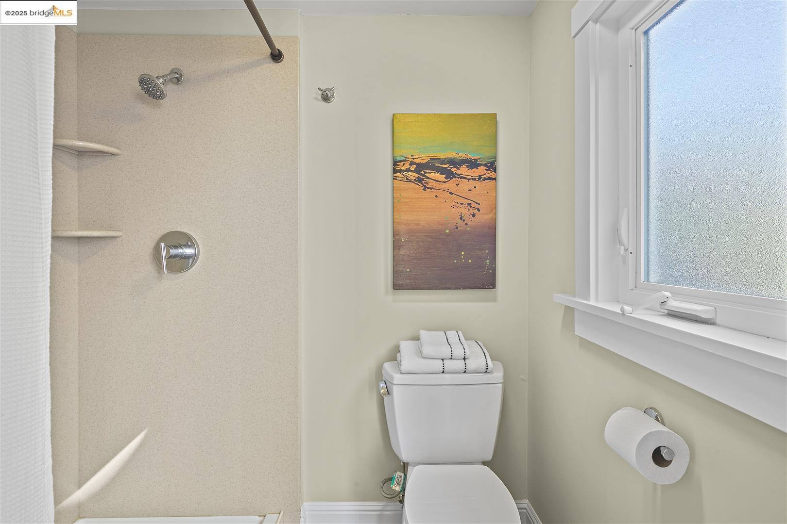 2439 Tenth Street, Unit B Berkeley, CA 94710 - Photo 15 of 16 a bathroom with a toilet sink and mirror