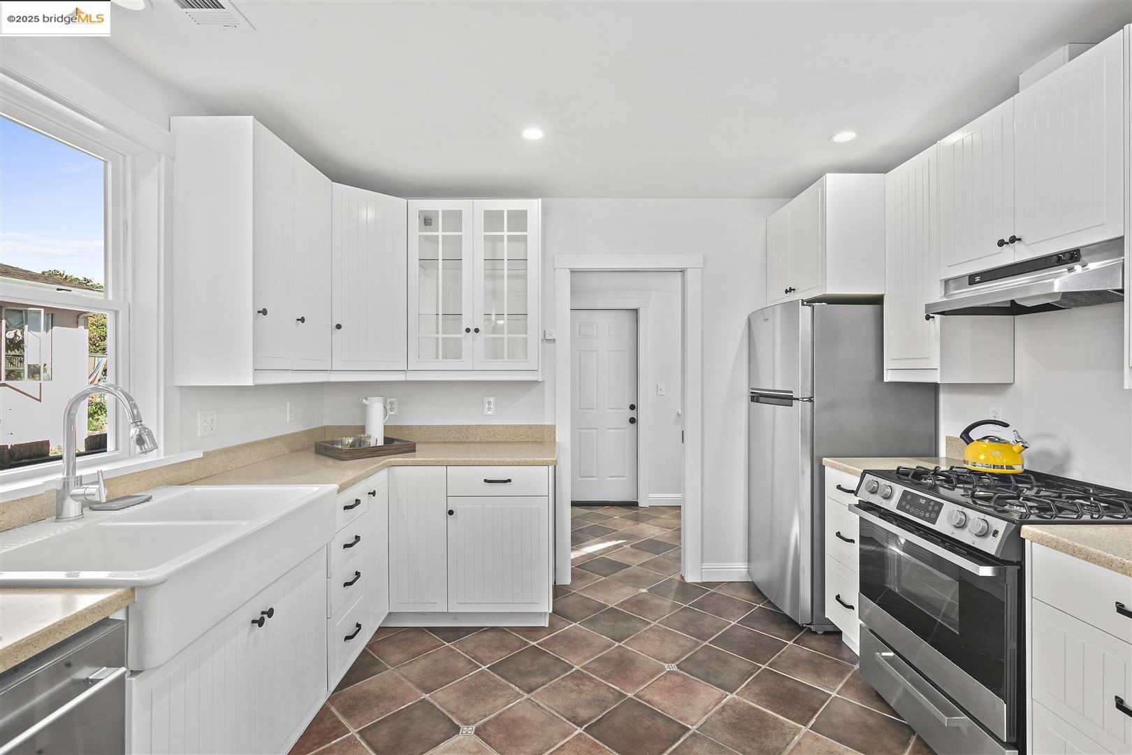 2439 Tenth Street, Unit B Berkeley, CA 94710 - Photo 7 of 16 a kitchen with stainless steel appliances a stove a sink and a refrigerator