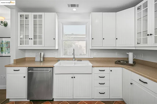 a kitchen with stainless steel appliances granite countertop a sink dishwasher and cabinets with wooden floor