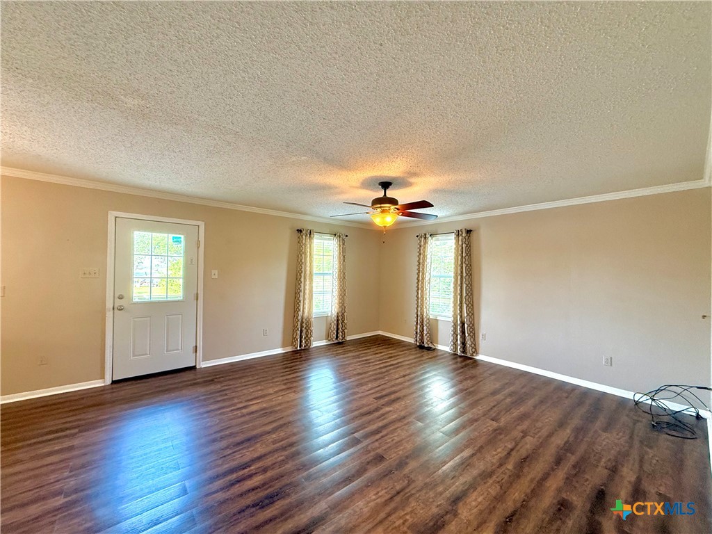 109 River Road Tivoli, TX 77990 - Photo 12 of 39 wooden floor in an empty room with a window