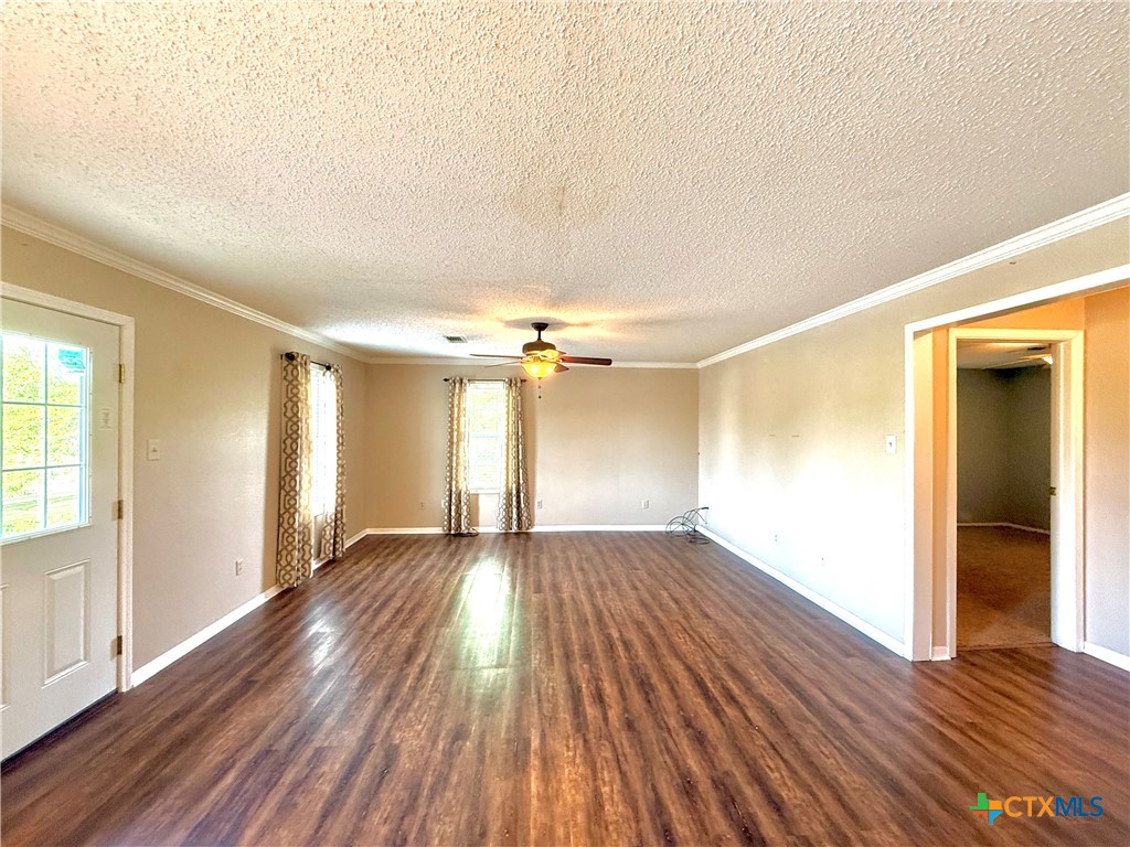 109 River Road Tivoli, TX 77990 - Photo 13 of 39 an empty room with wooden floor and windows