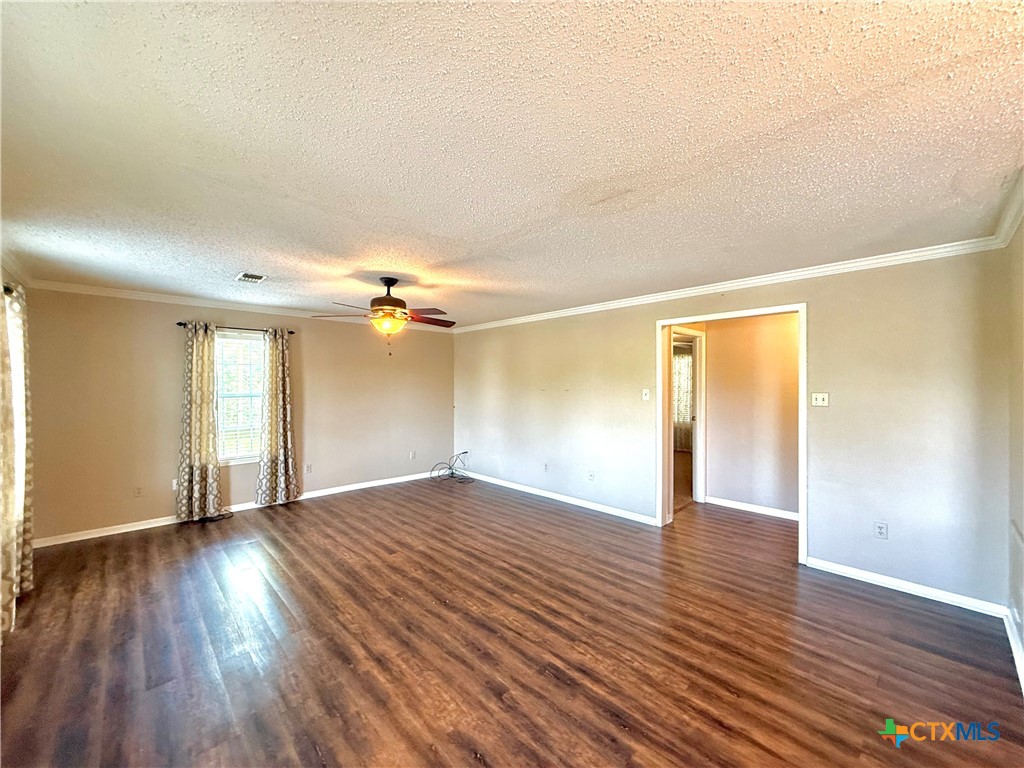 109 River Road Tivoli, TX 77990 - Photo 14 of 39 a view of an empty room with window and wooden floor