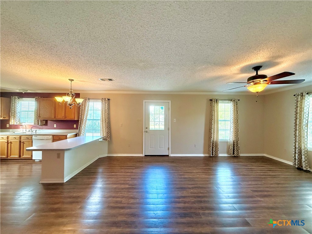 109 River Road Tivoli, TX 77990 - Photo 16 of 39 a view of an empty room and kitchen with wooden floor