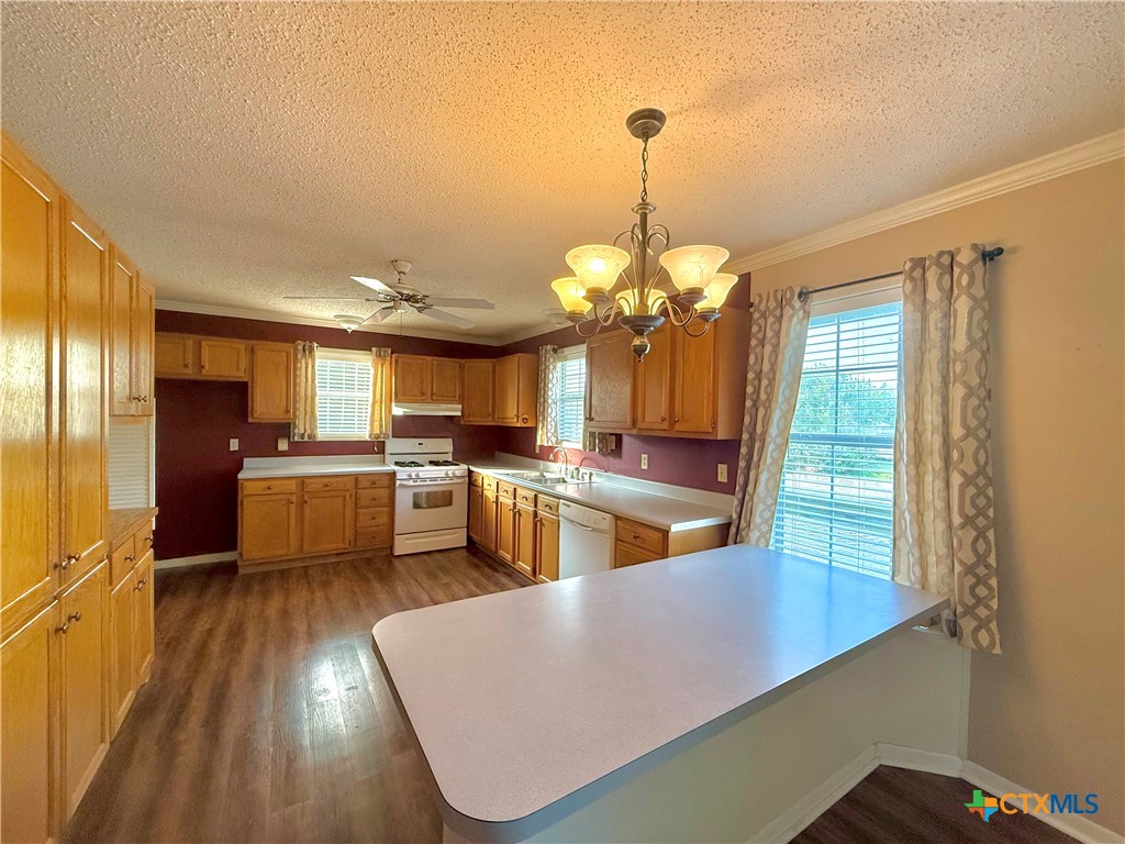109 River Road Tivoli, TX 77990 - Photo 18 of 39 a view of a kitchen with kitchen island a large counter top space a sink stainless steel appliances and cabinets
