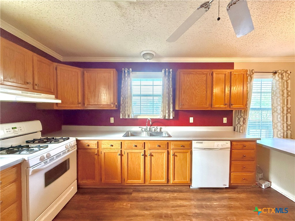 109 River Road Tivoli, TX 77990 - Photo 21 of 39 a kitchen with a stove a sink and a refrigerator