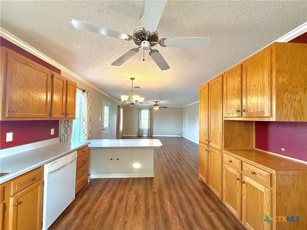 109 River Road Tivoli, TX 77990 - Photo 22 of 39 a kitchen with stainless steel appliances granite countertop a refrigerator a sink dishwasher a stove and white countertops with wooden floor