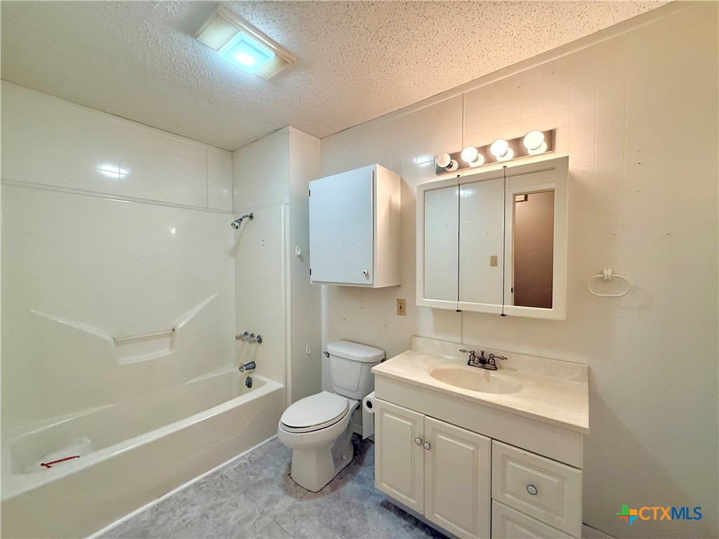 109 River Road Tivoli, TX 77990 - Photo 30 of 39 a bathroom with a toilet sink and mirror with bathtub