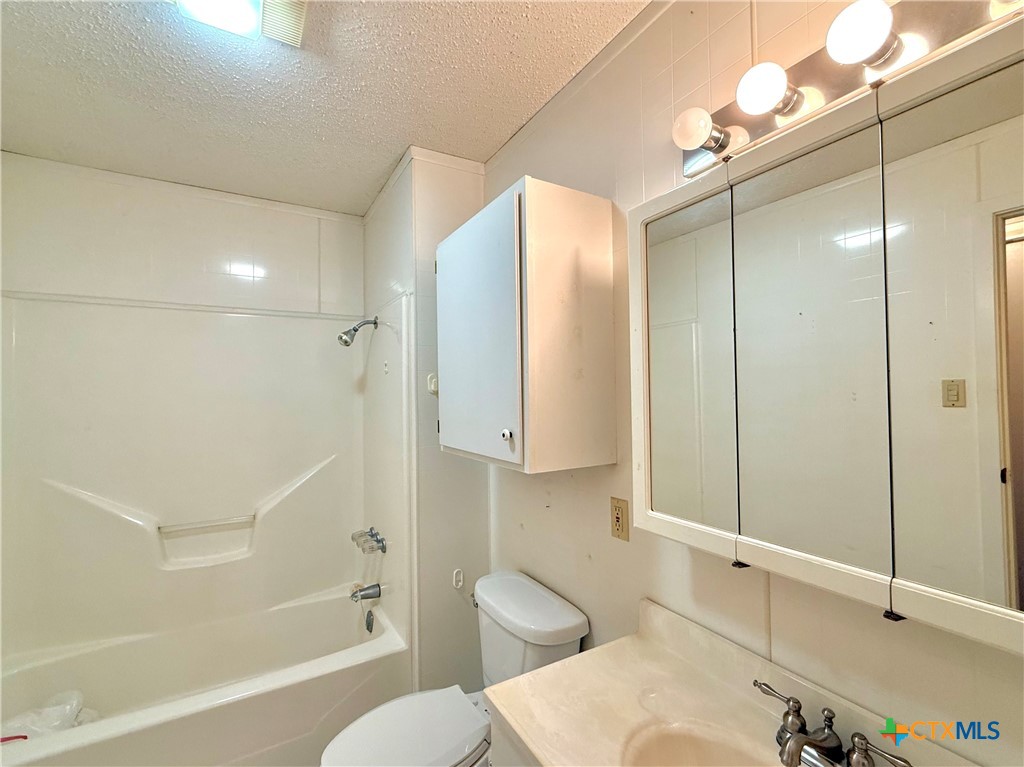 109 River Road Tivoli, TX 77990 - Photo 31 of 39 a bathroom with a sink a toilet and shower