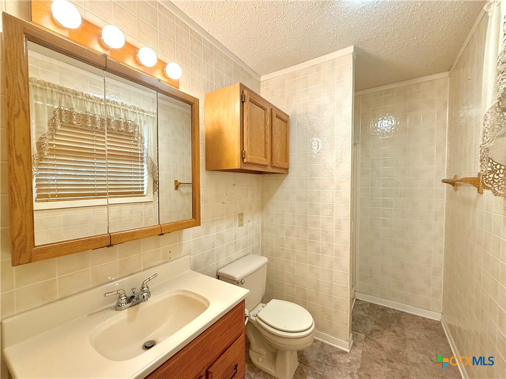 109 River Road Tivoli, TX 77990 - Photo 32 of 39 a bathroom with a sink a toilet and shower